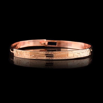 This dainty Hummingbird bracelet has a single, thin copper band with a clasp in the back. There are depictions of the Hummingbird carved into the band.