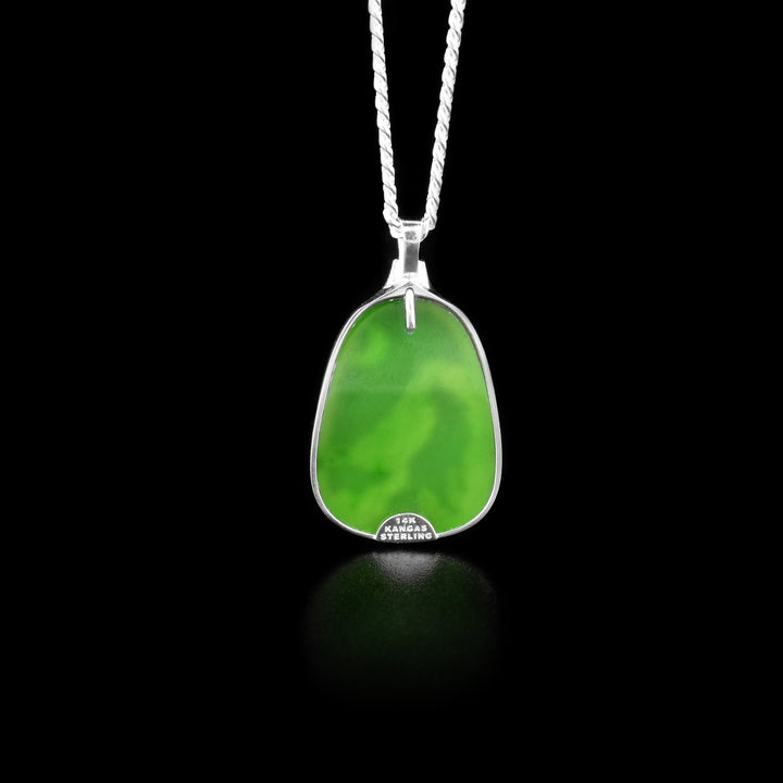 The back of this jade pendant is pure BC Jade and is green in colour.
