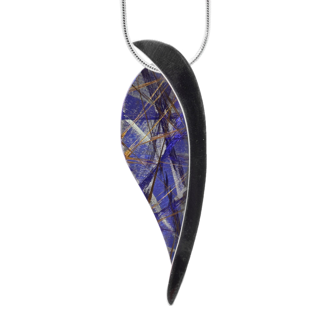 This titanium necklace is made from sterling silver and anodized titanium and has a feather shaped pendant. Half of the pendant is made from silver and the other part is light blue and has colorful designs that are achieved by anodizing the metal.