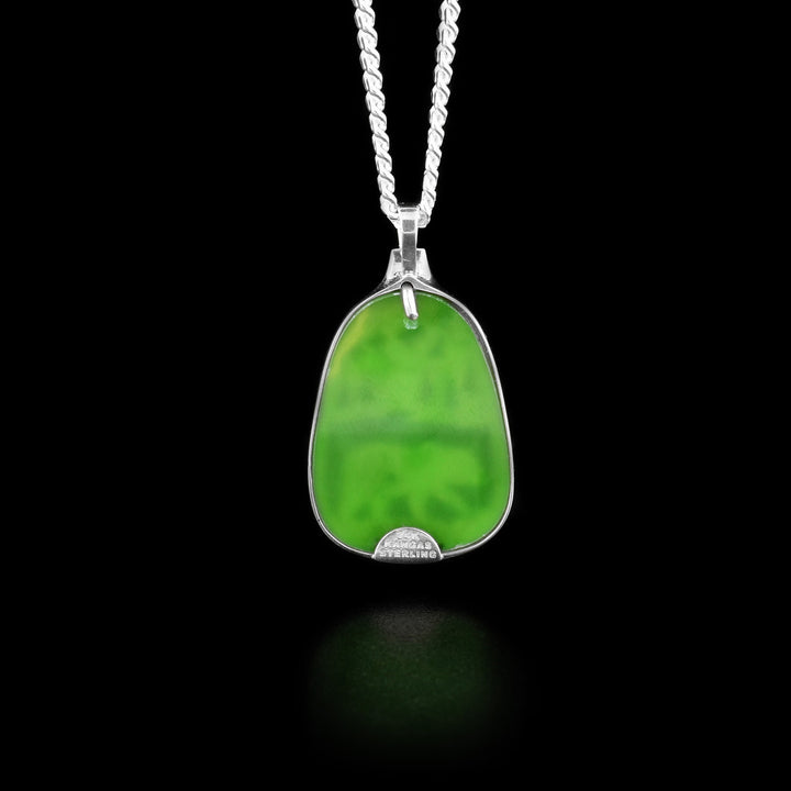 The back of this jade pendant is pure BC jade and is green in colour.