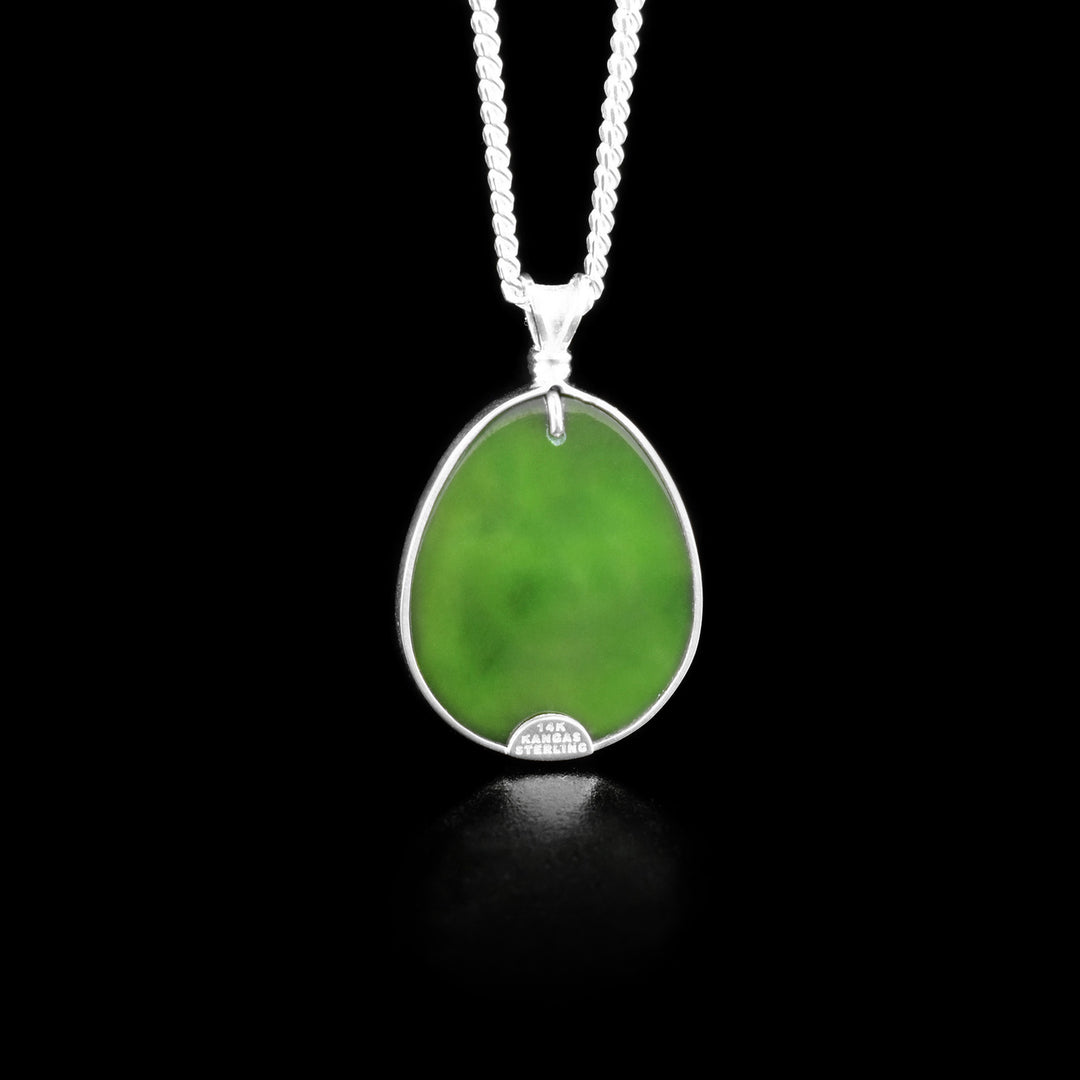 The back of this jade pendant is pure BC Jade and is green in colour.