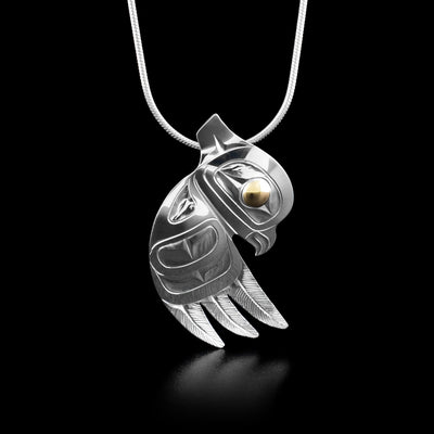 This owl necklace has the head of an owl facing downwards with a large spread out wing underneath. The wing has carvings representing the feathers of the legend.