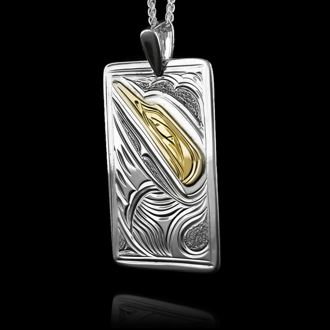 This sterling silver gold pendant has a short, rectangle shape and the Hummingbird legend is carved into the surface of it. The face of the legend is done in 14K gold and is done in a side profile. Its head is looking upwards and there is a wing below the head. There are small, dimpled textures in the background of the piece.