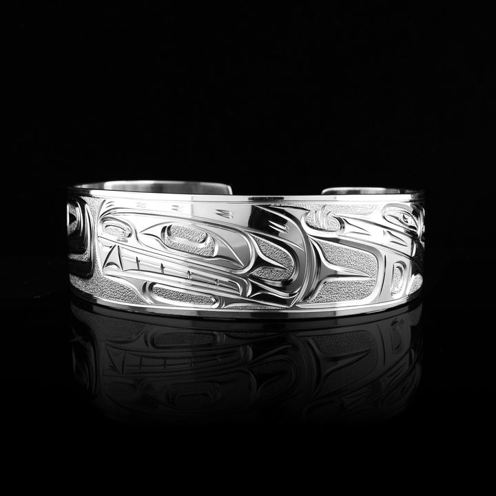 This sterling silver bracelet cuff is carved with the legend of the orca in an indigenous style.