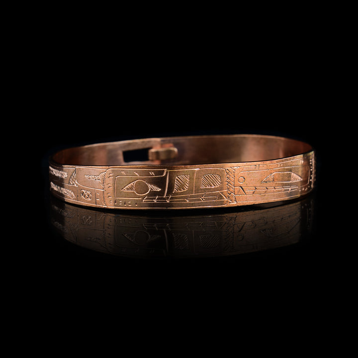 Hand-carved by Gilbert Pat, this copper clasp bracelet beautifully depicts the Orca and Wolf. Authentically crafted Northwest Coast Indigenous jewelry.