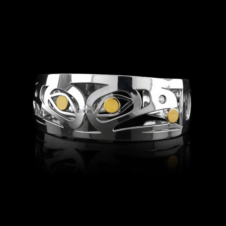 7/8" Sterling Silver & 14k Gold Raven Cuff - Ravens heads are back to back on the silver cuff holding a ball of light in their beaks made of 14k gold. There eyes are also 14k gold.