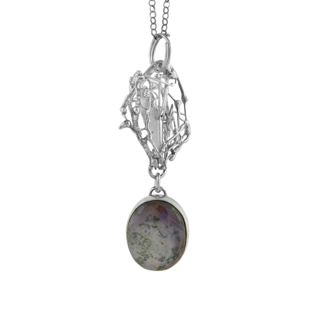 925 Silver is abstractly melted into strand of a circle and Star Sapphire sits below it as a perfectly circular Pendant