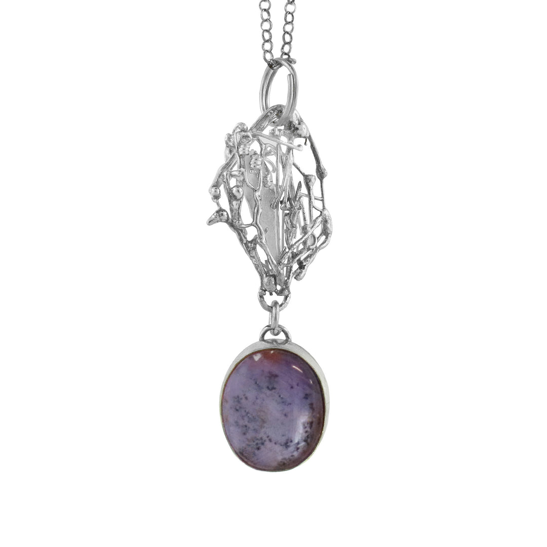 925 Silver is abstractly melted into strand of a circle and Star Sapphire sits below it as a perfectly circular Pendant