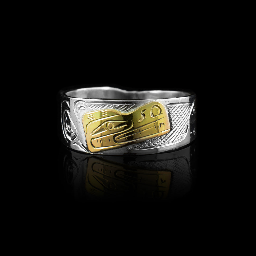 This sterling silver and 10k gold band by artist Graham Henry. Featuring the Bear legend hand-carved in gold against a solid silver band
