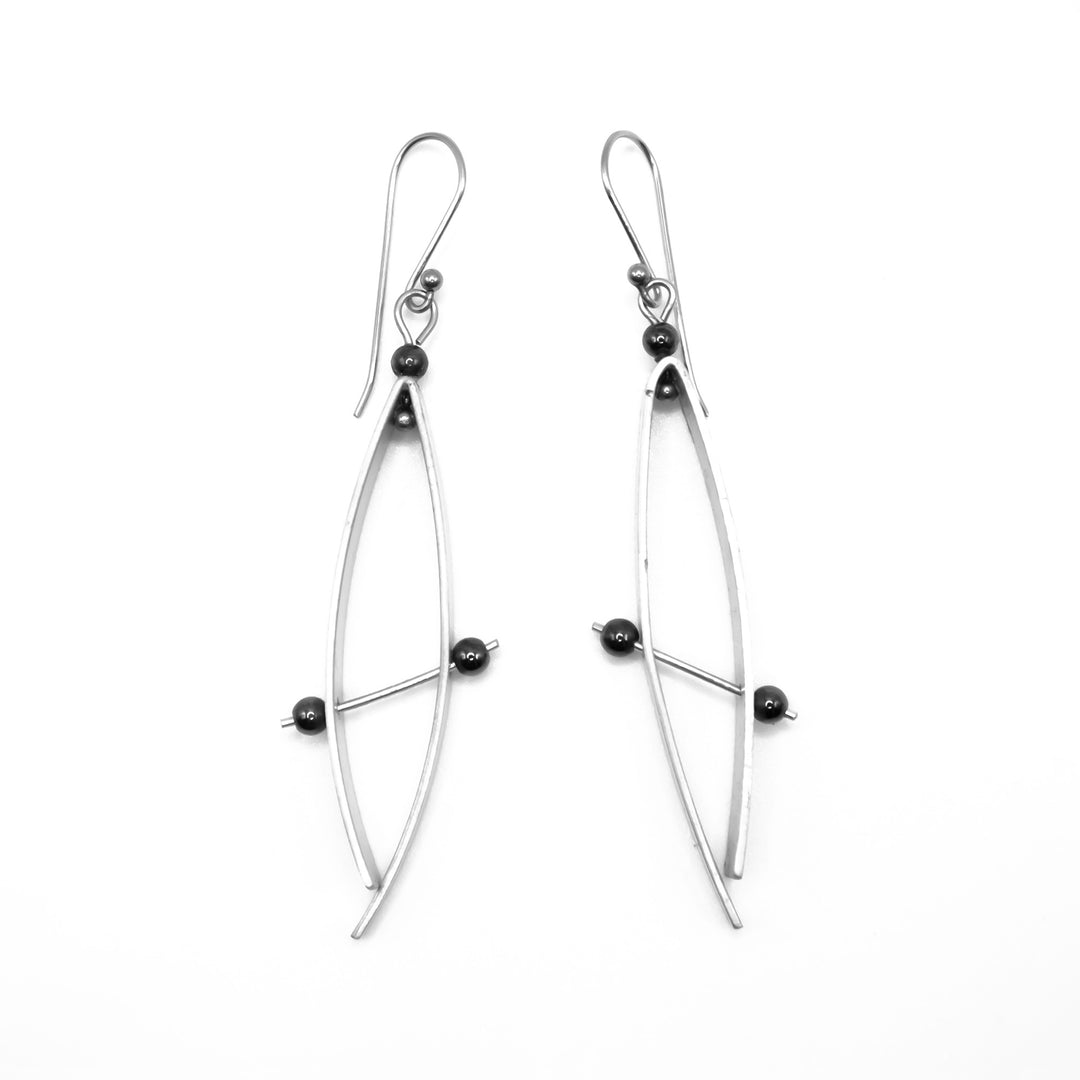 Abstract aluminum drop earrings with hematite beads and stainless steel hooks. By JR Franco.