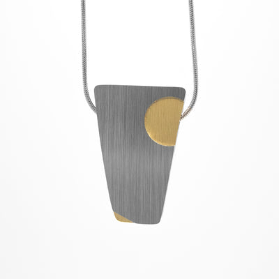 Curved pendant with uneven rectangle shape. Anodized and brushed aluminum. Silver colour with gold colour dots.
