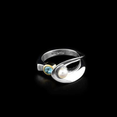 Sterling silver statement ring with faceted blue topaz set in 14K yellow gold and white freshwater pearl. Abstract design. By Ivan Dobren.