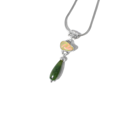 Polished Ethiopian rainbow opal set in silver below tubular, decorated bail. Teardrop of BC jade hangs below with adornment on top and bottom. All metal is sterling silver.