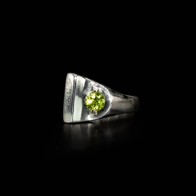 Sterling silver abstract ring with round, faceted peridot and 14K gold bolt adornment. By Ivan Dobren.
