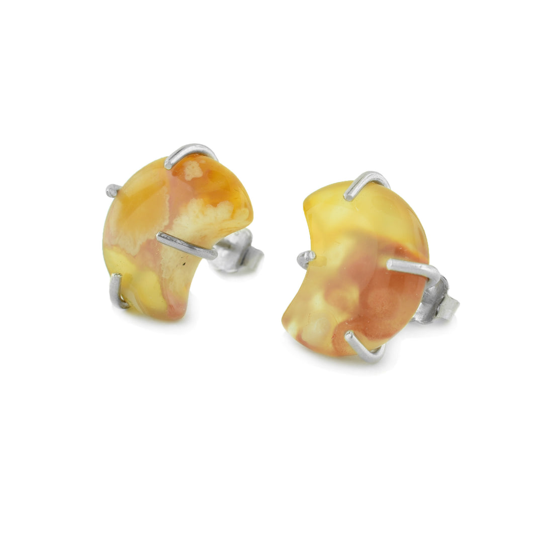 Handcrafted by Johanne Rousseau, these agate moon crescent stud earrings feature natural golden and honey-toned agate with unique marbling in every stone set on sterling silver studs.