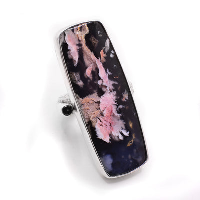 Large sterling silver statement ring with vertical rectangular piece of feather ridge plume agate next to black diamond. By Johanne Rousseau.