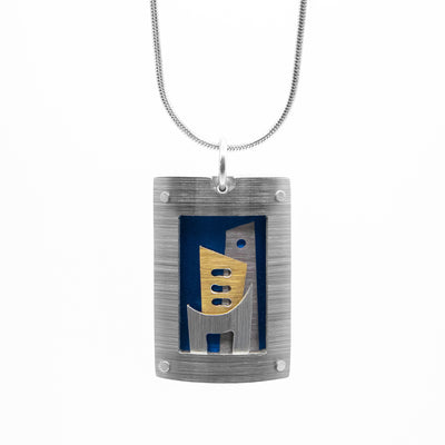 Rectangular pendant made of anodized and brushed aluminum. Large, curved silver-coloured frame. Inside is silver-coloured and gold-coloured cityscape against dark blue. Minimalist design.