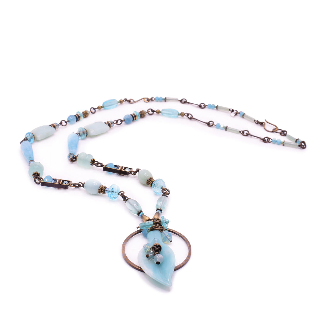 Honica featuring amazonite, aquamarine, and Austrian crystals. Handcrafted with lampwork brass for a timeless, sea-inspired look.