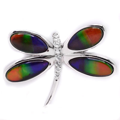 Sterling silver dragonfly brooch with ammolite in wings. White sapphires adorn body. By Enchanted Designs.