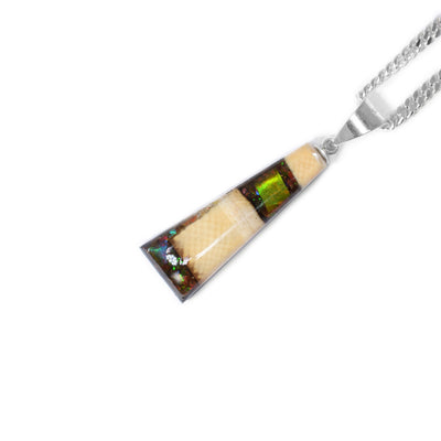 Triangular pendant handcrafted by Aryn Bowers. Made of ammolite and mammoth ivory. Sterling silver bail. Measures 1.3” x 0.25” including bail.