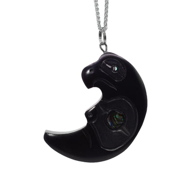 This crescent Moon pendant is made from argillite and has a depiction of the Eagles head shaped into the top of the piece.