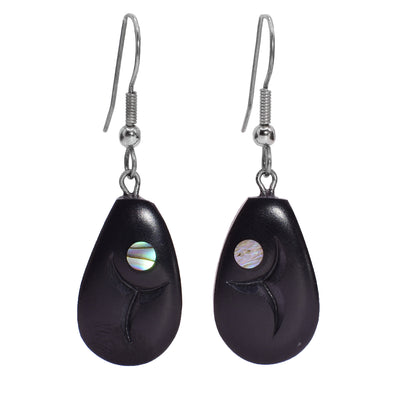 These abalone earrings have dangling teardrop shaped hangs made from argillite with Haida designs carved into them. There are is an abalone piece set in the top of the hangs.