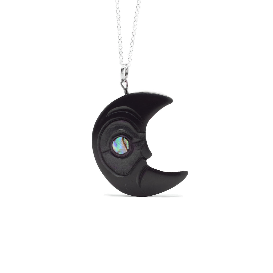 Hand-carved argillite half moon facing left. Abalone circle set in eye. By Haida artist Amy Edgars.