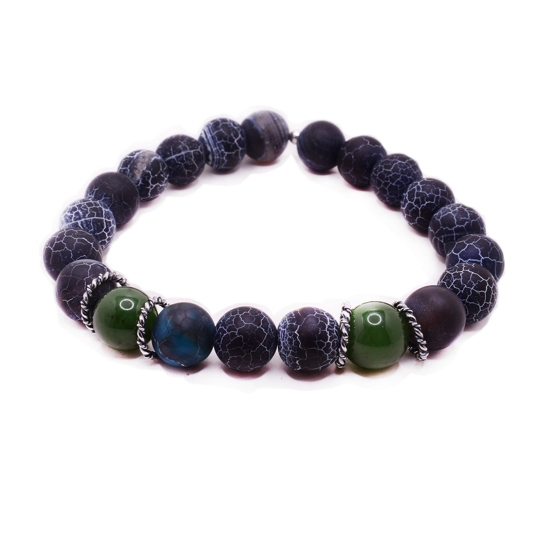 This jade bead bracelet that has agate and jade beads. There are two jade beads in the front, they have three agate beads between them. The rest of the beads around the bracelet are agate. 