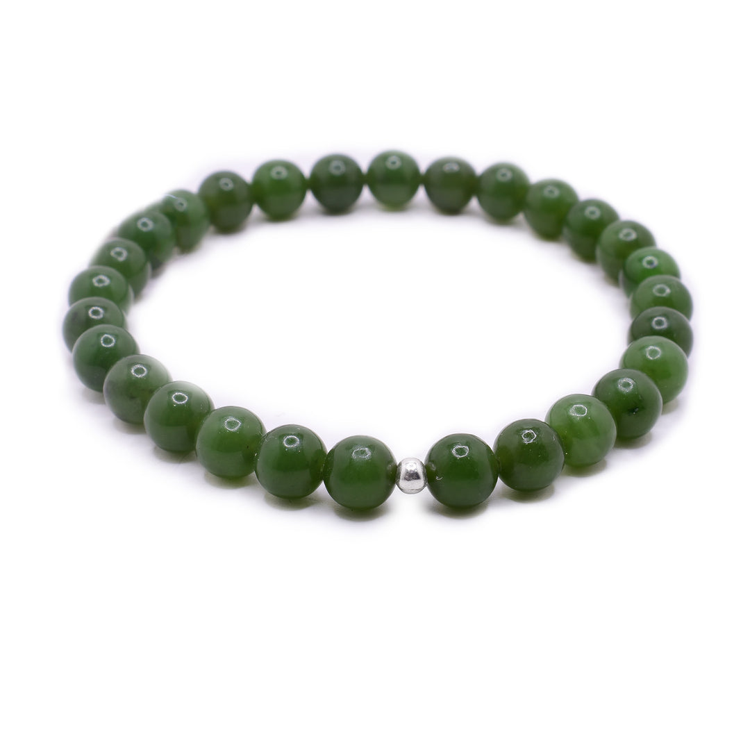 This jade bead bracelet has 6mm, spherical beads made from BC jade. There is a small sterling silver bead on the bracelet.