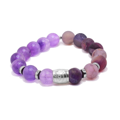 This beaded sterling silver, agate and amethyst bracelet has sphere gem beads and flat circle silver spacers. There is a spirit bead featured on the piece and has a depiction of the Hummingbird carved into the surface of the piece.