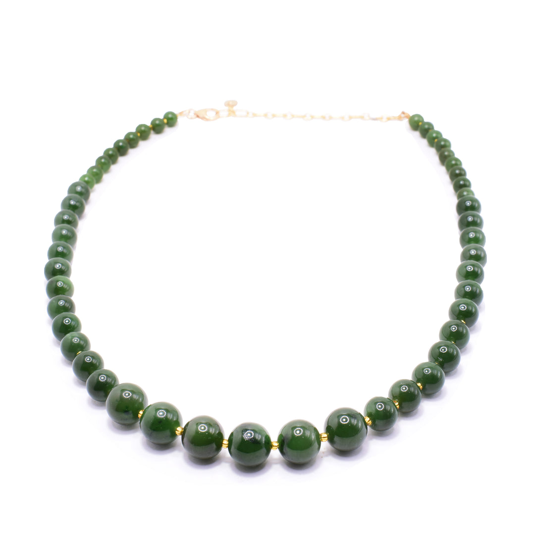 Beaded jade with gold necklace has different sized, sphere shaped jade beads with small, gold filled beads between the gemstone beads. The jade beads get uniformly  larger as the get closer to the center.