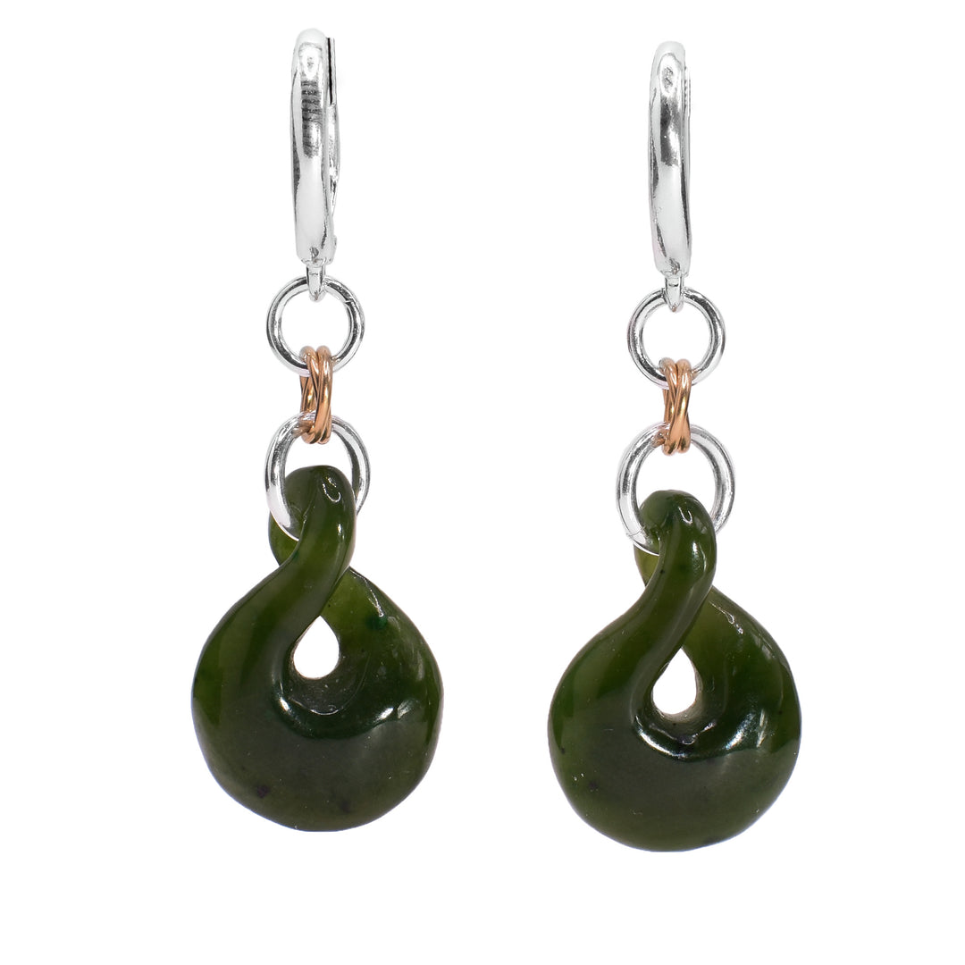 These dangling jade earrings have sterling silver and gold filled chain linked holding large jade hangs. The hangs have a hourglass round shape with a twist in the middle.