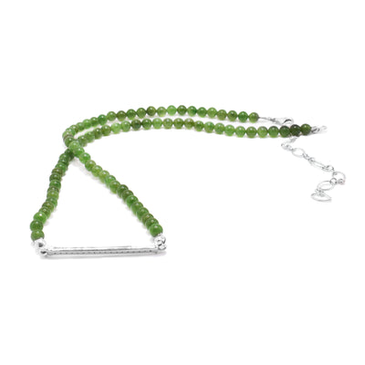 This cubic zirconia necklace has small, sphere beads made from grade a jade gems. There is a horizontal bar pendant made from sterling silver that displayed cubic zirconia gems.