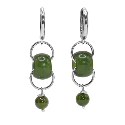 These drop jade earrings have sterling silver chain links connected through jade beads. There are small, sphere jade charms dangling at the bottom of these funky drop earrings.