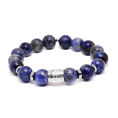 This sterling silver and jasper bracelet has sphere beads made from jasper and flat circle hematite spacers. There is a spirit bead featured on the piece with a depiction of the Hummingbird carved into it.
