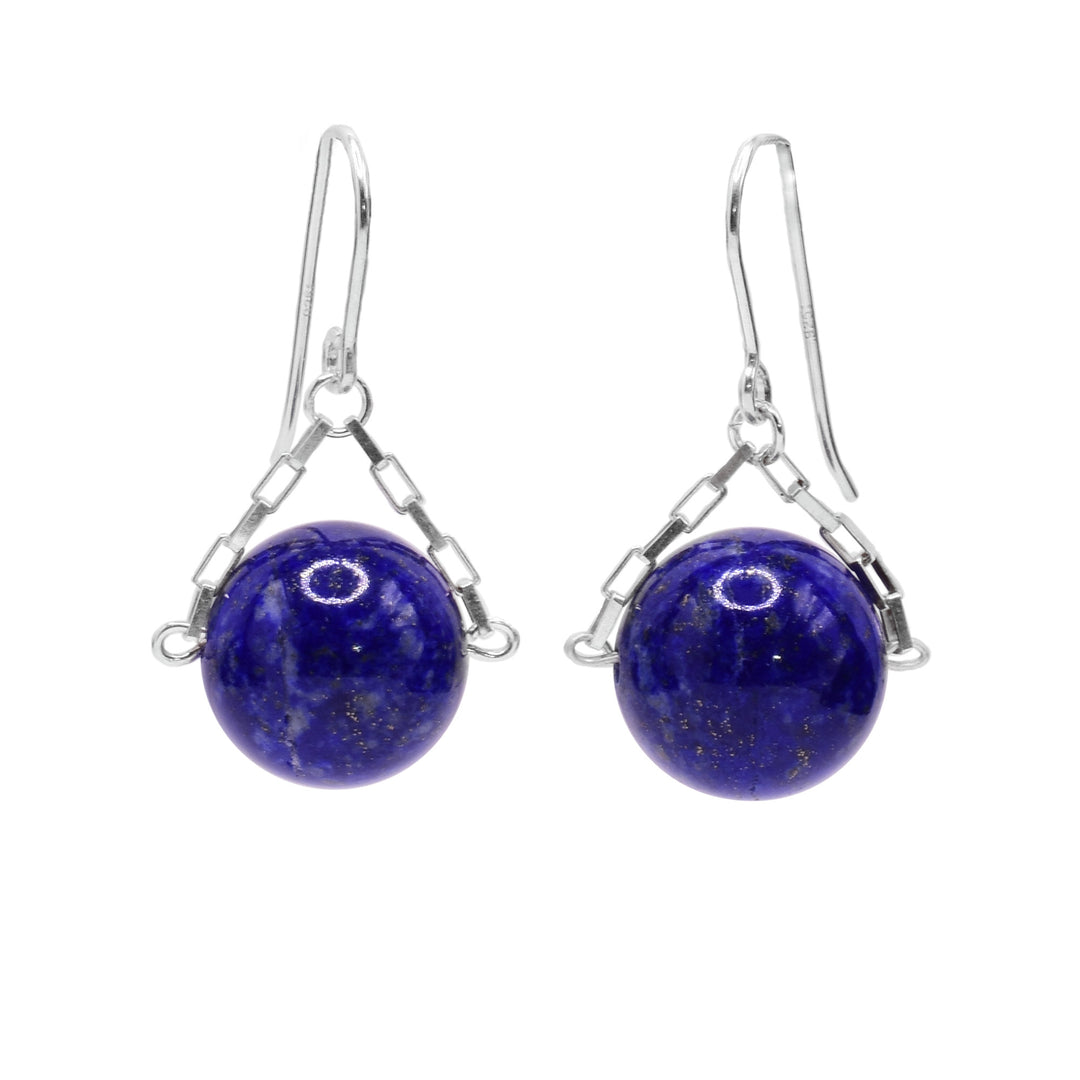 These lapis lazuli drop earrings have small, sterling silver chains attached to the hooks and to either side of the lapis lazuli hangs. The lapis lazuli are large spheres and dangle from the small chains.
