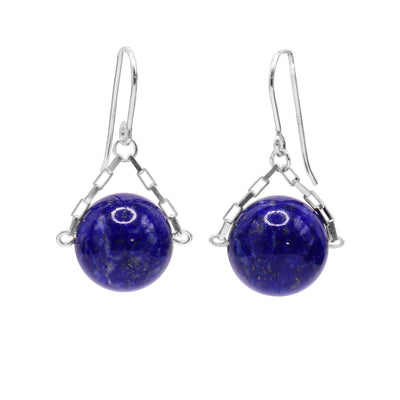 These lapis lazuli drop earrings have small, sterling silver chains attached to the hooks and to either side of the lapis lazuli hangs. The lapis lazuli are large spheres and dangle from the small chains.