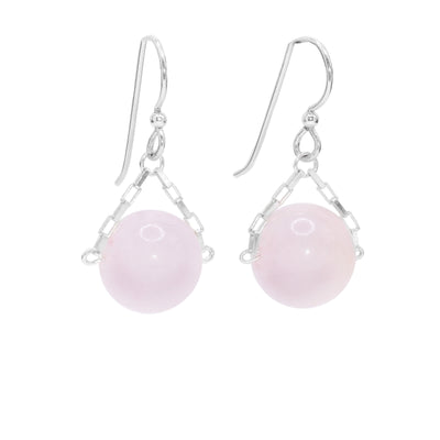 These rose quartz drop earrings have small, sterling silver chains attached to the hooks and to either side of the rose quartz hangs. The quartz are large spheres and dangle from the small chains.
