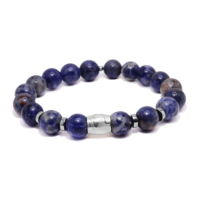 This sterling silver and sodalite gemstone bracelets has sphere beads made from the gems and flat circle silver spacers. There is a spirit bead featured on the piece with a depiction of the Orca carved into it.