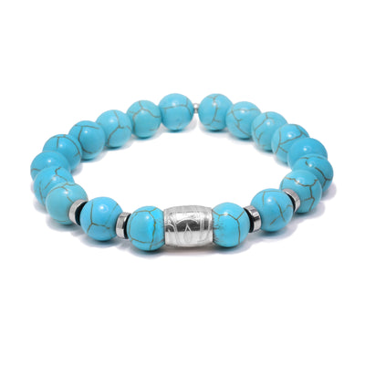 This sterling silver and turquoise bracelet as sphere beads made from the gems and flat circle silver spacers. There is a spirit bead featured on the piece with a depiction of the Eagle carved into it.