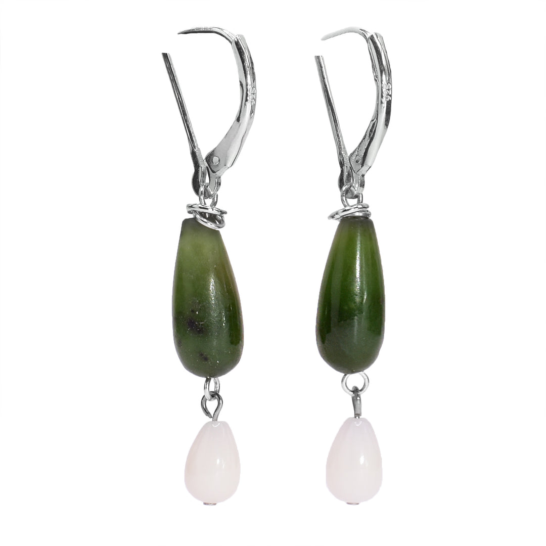 These long drop jade earrings have been made using genuine jade, pink coral and sterling silver. There are long jade hangs with pink coral charms dangling from the jade.