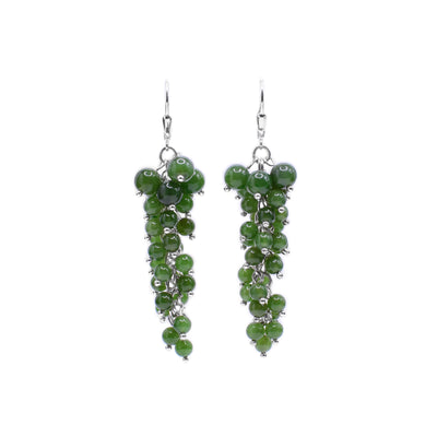 These dangling grape earrings are made from sterling silver and BC jade. The earrings are made up of jade beads linked together with silver that look like a bunch of grapes.