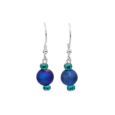 These dangling gemstone earrings have been made with blue agate and glass beads to create this piece. The hangs are made from a large, blue agate bead with turquoise glass beads above and below it.