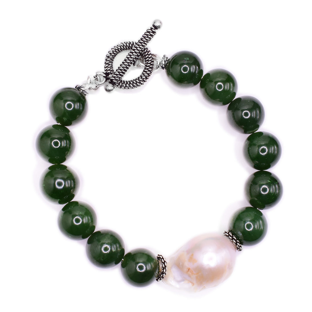 This beaded jade bracelet is made from freshwater, baroque pearls and grade A BC jade. There are medium spherical jade beads with one large, oval pearl bead.