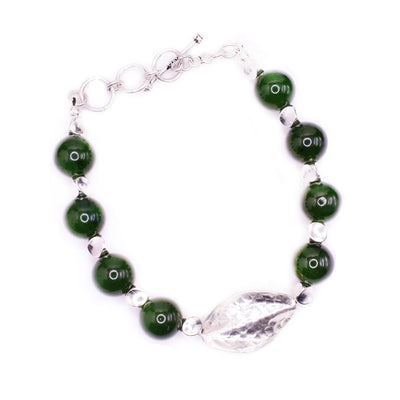 This grade A jade bead bracelet has a sterling silver chain and leaf charm on the piece.