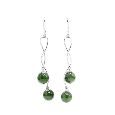 These dangling jade earrings are made from sterling silver wires and BC jade balls. The hangs are made from twisted silver wires that cradle the jade balls.