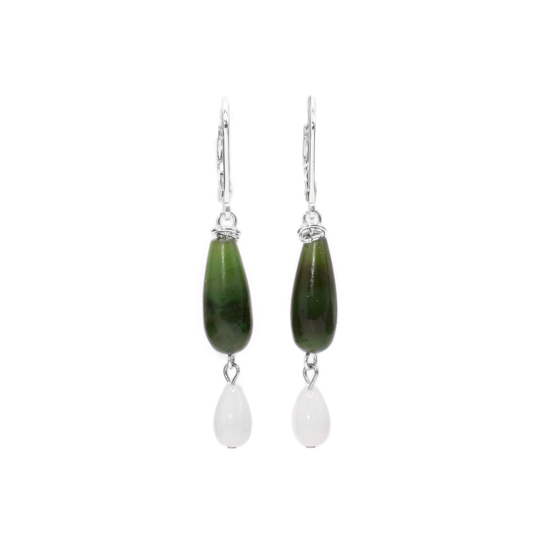 These BC jade earrings are long and teardrop shaped and have shorter, white teardrop coral hangs below them. The beads are linked together with sterling silver.