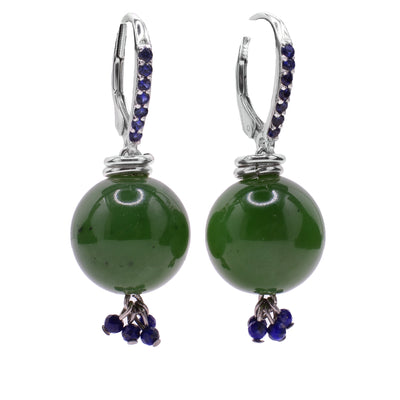 These jade earrings have large, sterling silver lever back hooks with blue cubic zirconia on the front of them. The dangles are made from large jade spheres and has lapis beads dangling at the bottom.