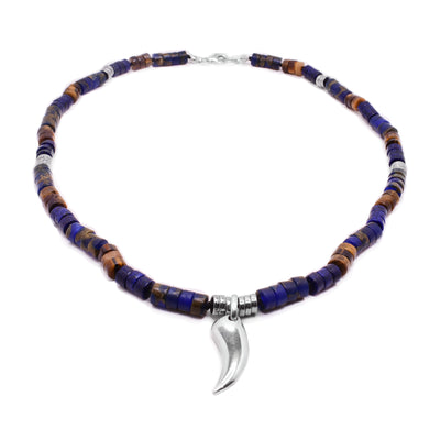 This silver pendant necklace has beads made out of sterling silver, lapis, jasper, and hematite. There is also a claw shaped pendant made from sterling silver.