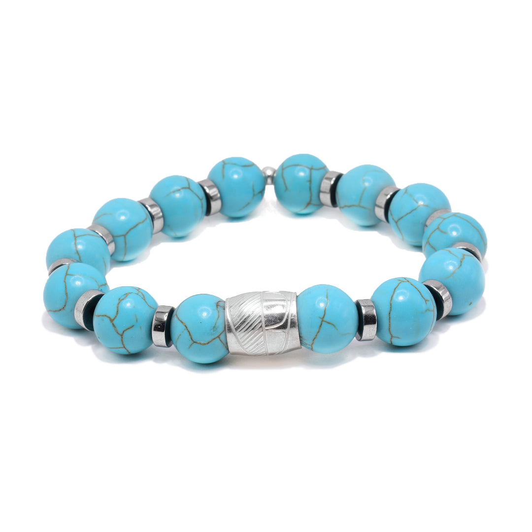 This sterling silver and turquoise bracelet as sphere beads made from the gems and flat circle silver spacers. There is a spirit bead featured on the piece with a depiction of a feather carved into it.